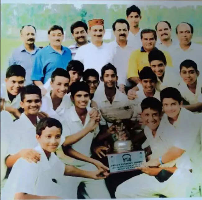 Shubman Gill and Abhishek Sharma with the winning U-14 Dhruv Pandove Trophy. (Special Arrangement)
